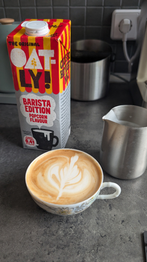 A flat white made with Oatly Popcorn Flavor